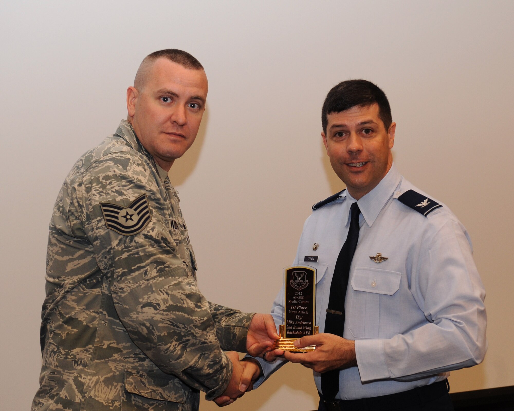 Tech. Sgt. Mike Andriacco, 2nd Bomb Wing Public Affairs, receives the 2012 Air Force Global Strike Command Media Award for best news article from Col. Andrew Gebara, 2nd BW commander, on Barksdale Air Force Base, La., June 12, 2013. (U.S. Air Force photo/Airman 1st Class Benjamin Gonsier)
