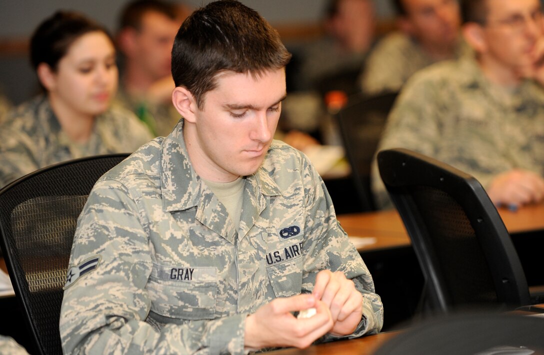 Airman 1st Class Timothy Gray, 28th Aircraft Maintenance Squadron aerospace maintenance technician, completes an exercise during an annual Sexual Assault Prevention and Response training class in the Rushmore Center on Ellsworth Air Force Base, S.D., June 10, 2013. Airmen took part in an interactive exercise that illustrated the healing effects of support sources during a victim's recovery process at the conclusion of the class. (U.S. Air Force photo by Airman 1st Class Ashley J. Thum/Released)