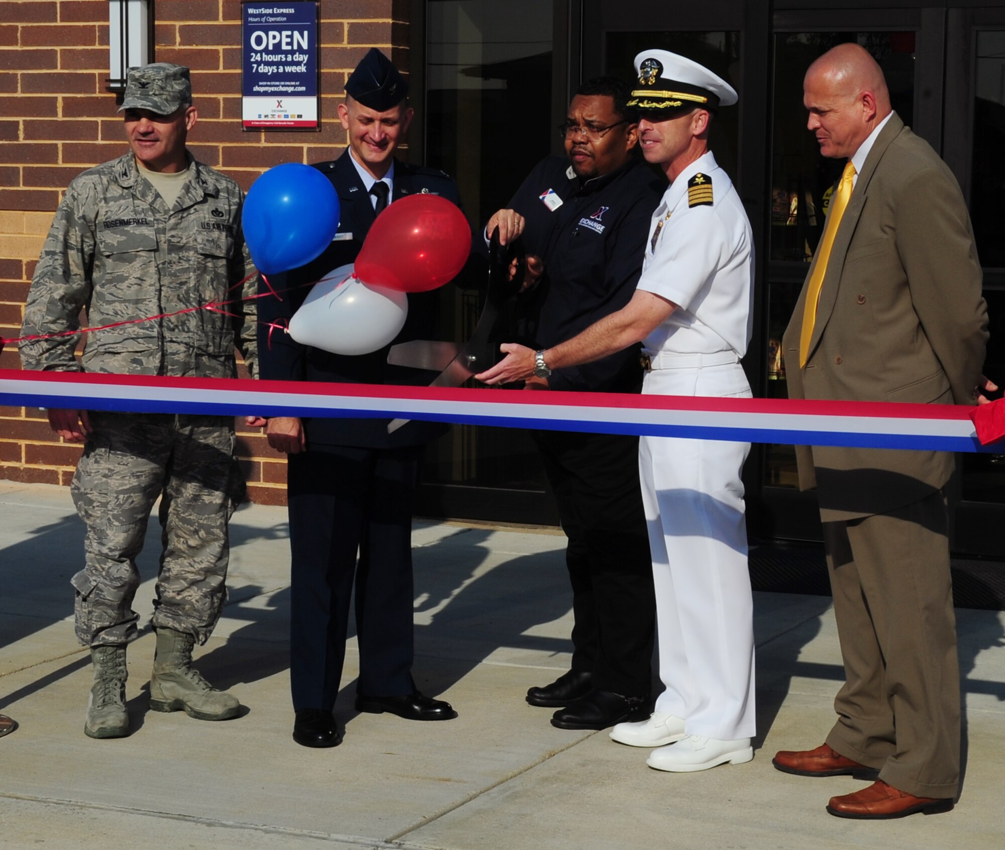 Team Andrews members prepare to cut the ribbon for the Express Shoppette grand opening at Joint Base Andrews, Md., June 12, 2013. The new Express Shoppette is open 24/7 and offers gas pumps, car vaccume stations, and a variety of food and beverage items. (U.S. Air Force photo/Airman 1st Class Erin O’Shea)