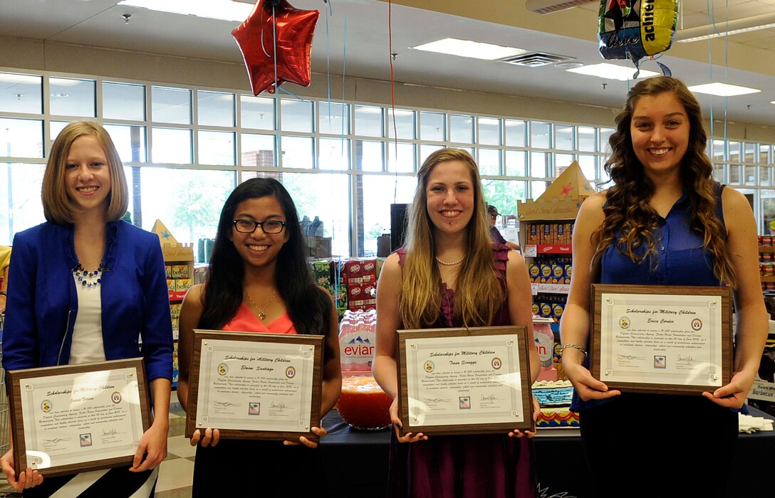 (From left) Jessie Verive, 17; Elaine Santiago, 17; Tresa Scruggs, 18; and Erica Corder, 18, pose for a group photo at the Commissary to showcase scholarships awarded to them at Fort Eustis, Va., June 6, 2013. All four high school students were awarded a $1,500 scholarship from the Scholarships for Military Children program. The Defense Commissary Agency participates in the program by accepting applications of eligible children. The recipients went through a selection process where scholarship managers reviewed the applicant’s grade-point averages, extracurricular and volunteer activities, and essay submissions. (U.S. Air Force photo by Staff Sgt. Dana Hill/Released) 
