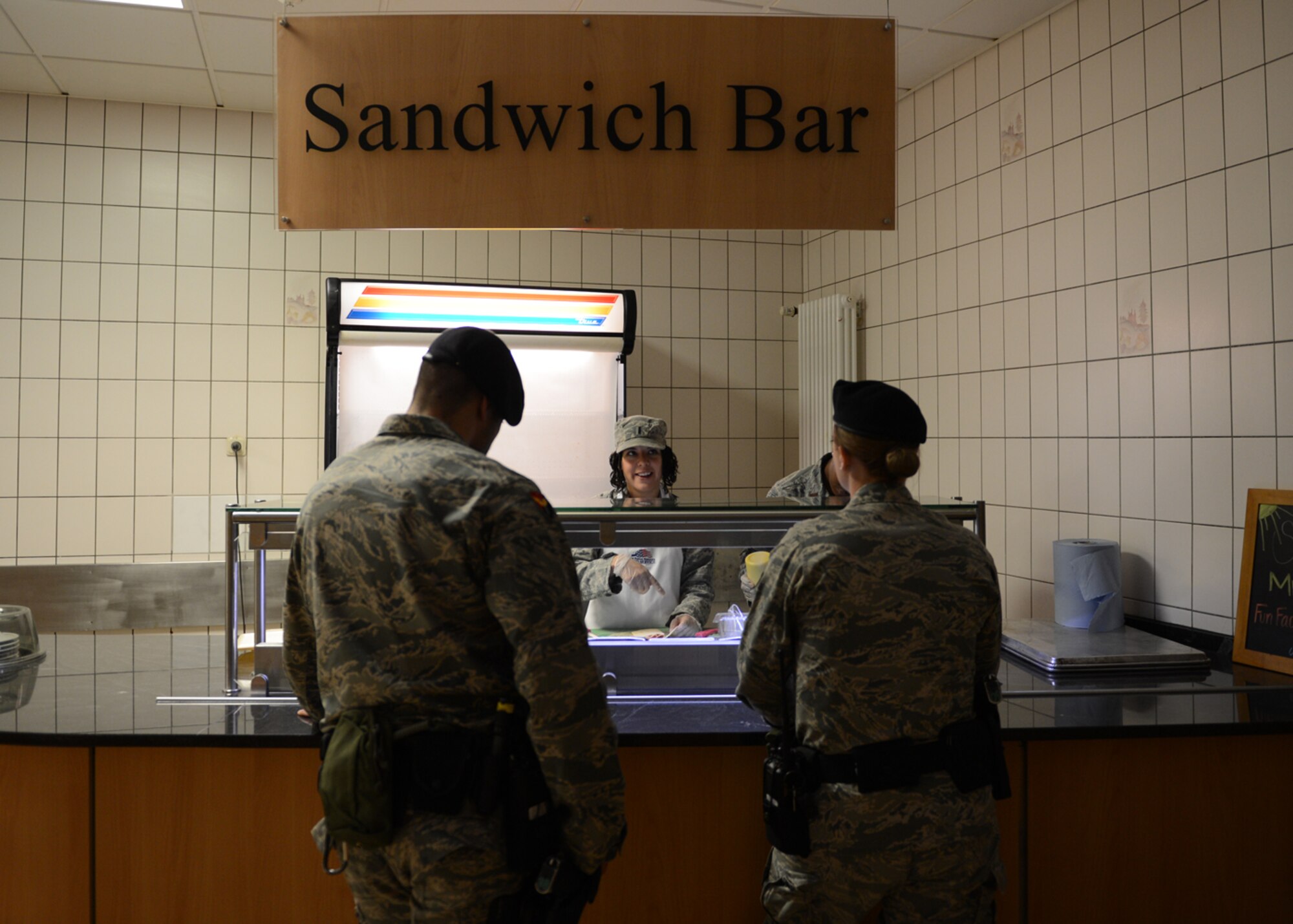 SPANGDAHLEM AIR BASE, Germany – U.S. Air Force 1st Lt. Jessica McAllister, 606th Air Control Squadron, donates her time at the the Mosel Dining Facility to keep the sandwich bar open for airmen. The 52nd Force Support Squadron Sustainment Flight is offering training for volunteers after low manning resulted in limited service.  (U.S. Air Force photo by Staff Sgt. Nathanael Callon/Released)