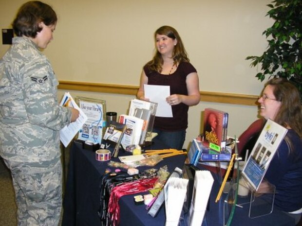 A Joint Base Charleston Airman speaks with representatives from one of the universities in attendance at an Education Fair May 30, 2013, at JB Charleston – Air Base, S.C. (U.S. Air Force photo/Courtesy photo)     