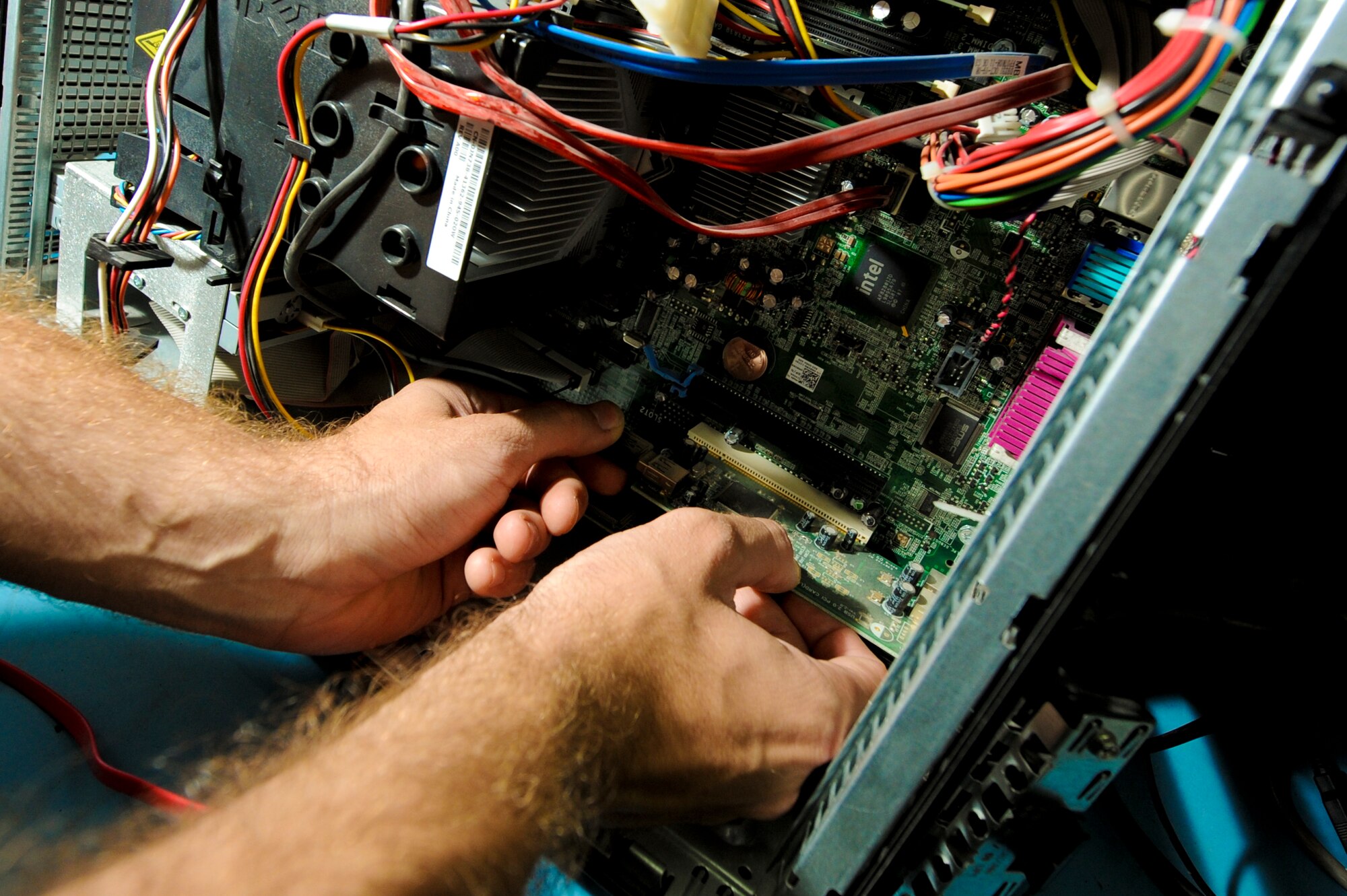 U.S. Air Force Airman 1st Class Braden Hoglan, 380th Expeditionary Communication Squadron small computer repair technician, removes the USB card from a computer at an undisclosed location in Southwest Asia, June 11, 2013. Hoglan and the small computers shop are able to remove individual pieces of hardware from a computer to keep the unit in working order.  Hoglan is native to Amesbury, Mass., and is deployed from Ramstein Air Base, Germany. (U.S. Air Force photo by Staff Sgt. Joshua J. Garcia)