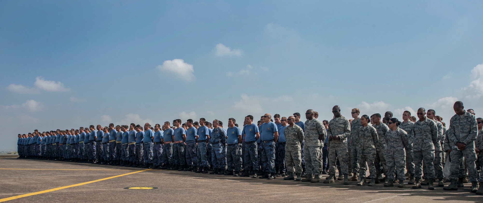 U.S. and Turkish air force members gather during a foreign-object-debris walk June 12, 2013, at Incirlik Air Base, Turkey. U.S. and Turkish airmen from the 39th Air Base Wing and the 10th Tanker Base Command split into groups to remove debris that could cause damage to aircraft. (U.S. Air Force photo by Senior Airman Anthony Sanchelli/Released)