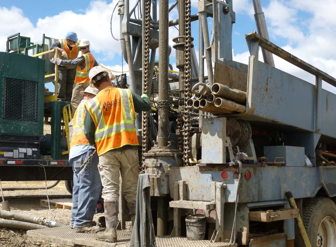 Workers install a relief well in Williston, North Dakota.