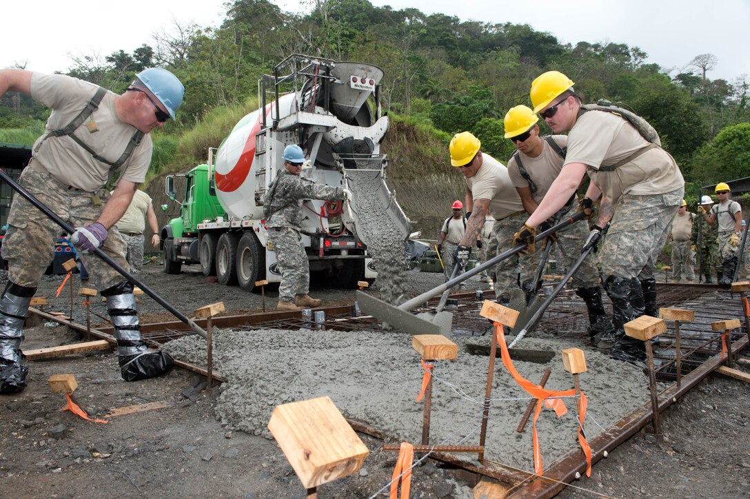 Soldiers from the 284th Engineer Company, based in Seagoville, Texas, spread concrete for a foundation of a clinic in Achiote, Panama, during the Beyond the Horizon exercise, April 17, 2013. Beyond the Horizon is a U.S. Southern Command-sponsored, U.S. Army South-planned and -led annual humanitarian and civic assistance exercise that provides construction and medical assistance to partner nations throughout Central and South America and the Caribbean. U.S. Army photo by Kaye Richey
