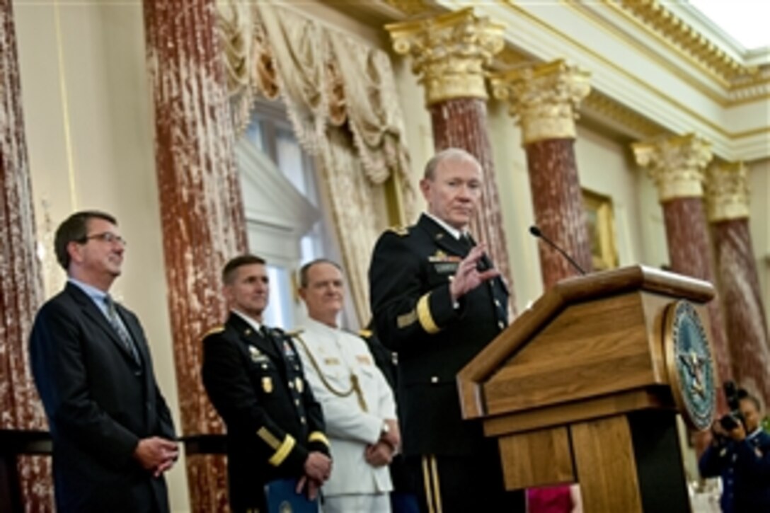 Army Gen. Martin E. Dempsey, chairman of the Joint Chiefs of Staff, makes remarks as Deputy Defense Secretary Ash Carter, far left, looks on during a reception for foreign defense attaches at the State Department in Washington, D.C., June 11, 2013. Hosted by Defense Intelligence Agency Director Army Lt. Gen. Michael T. Flynn, the reception marks the introduction of the attache corps to Defense Department leaders. 