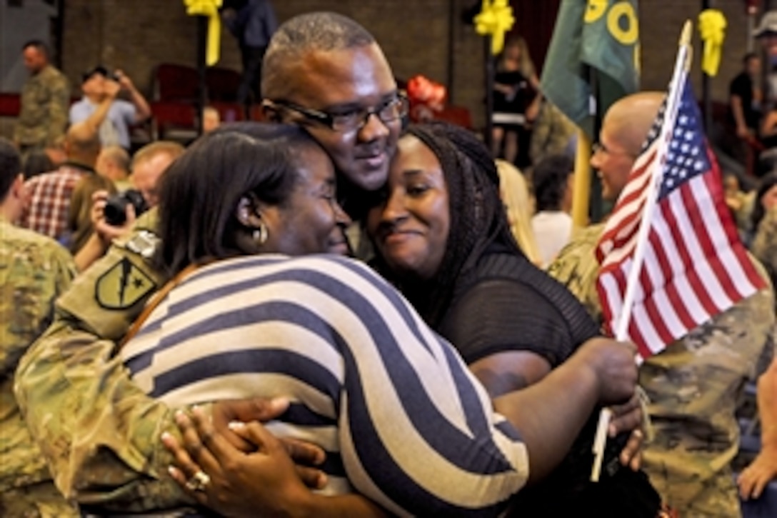 Army Staff Sgt. Samuel Spencer III gets an embrace from his family after returning from a nine-month deployment to Afghanistan at the Lawrenceville Armory in Trenton, N.J., June 6, 2013, Spencer was assigned to the 508th Military Police Company, which provided security and force protection, and advised the Afghan national police force in the Kabul region.