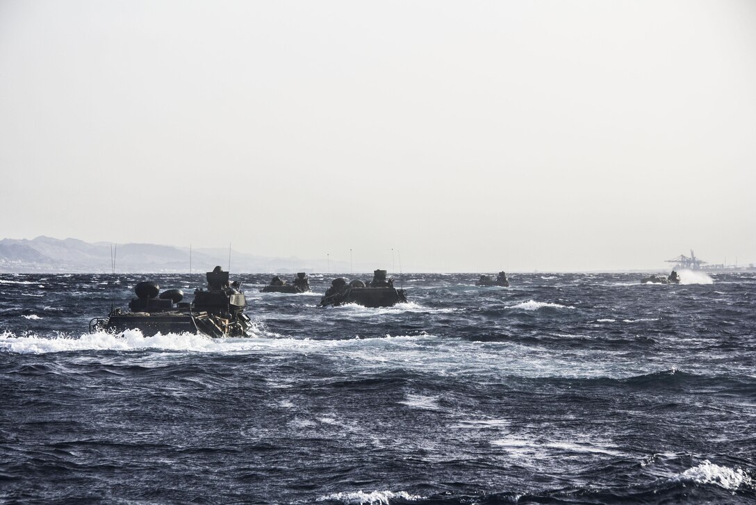 The amphibious assault vehicles of Battalion Landing Team 3/2, 26th Marine Expeditionary Unit, conduct an amphibious landing from the USS Carter Hall, off the coast of Jordan, June 6, 2013. The 26th MEU is a Marine Air-Ground Task Force forward-deployed to the U.S. 5th Fleet area of responsibility aboard the Kearsarge Amphibious Ready Group serving as a sea-based, expeditionary crisis response force capable of conducting amphibious operations across the full range of military operations.
(U.S. Marine Corps photo by Cpl. Michael S. Lockett/Released)
