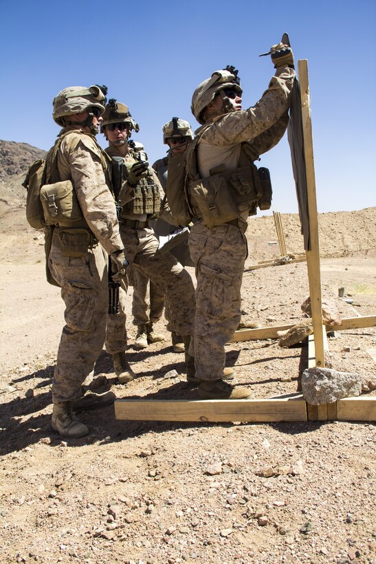 U.S. Marines assigned to Lima Company, Battalion Landing Team (BLT) 3/2, 26th Marine Expeditionary Unit (MEU), evaluate their shot groups after conducting live fire drills with M27 Infantry Automatic Rifles, during Exercise Eager Lion 13, June 10, 2013. Exercise Eager Lion 2013 is an annual, multinational exercise designed to strengthen military-to-military relationships and enhance security and stability in the region by responding to realistic, modern-day security scenarios. The 26th MEU is a Marine Air-Ground Task Force forward-deployed to the U.S. 5th Fleet area of responsibility aboard the Kearsarge Amphibious Ready Group serving as a sea-based, expeditionary crisis response force capable of conducting amphibious operations across the full range of military operations. (U.S. Marine Corps photograph by Lance Cpl. Juanenrique Owings, 26th MEU Combat Camera/Released)