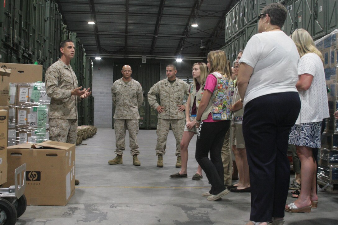 Gunnery Sgt. Victor Gonzales, the warehouse chief with 2nd Marine Aircraft Wing supply, speaks to Girl Scouts with troop 391 out of Raleigh, N.C., shortly after the scouts delivered cookies to Cherry Point June 5. 