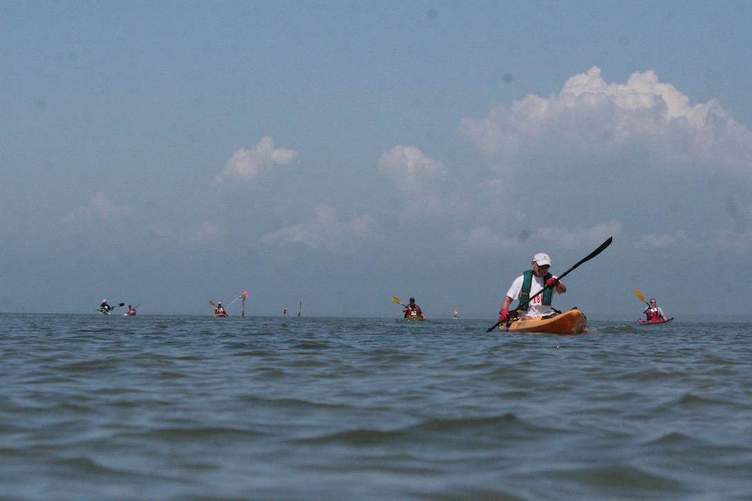 Competitors approach the finish line of the Kayak for the Warriors race Saturday at Pine Knoll Shores.  The race is in its sixth year and was 3.2 miles long. 