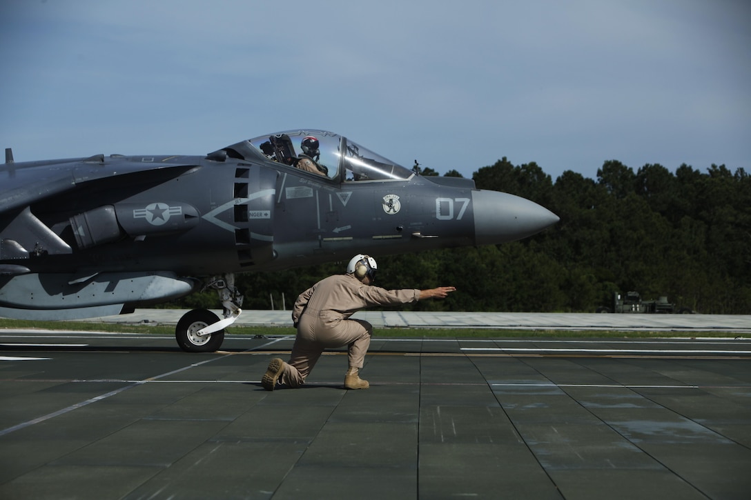Capt. Craig Freeman, an AV-8B Harrier pilot with Marine Attack Squadron 223, gives the signal for an AV-8B Harrier to take off during carrier qualifications at Marine Corps Auxiliary Landing Field Bogue Monday. 