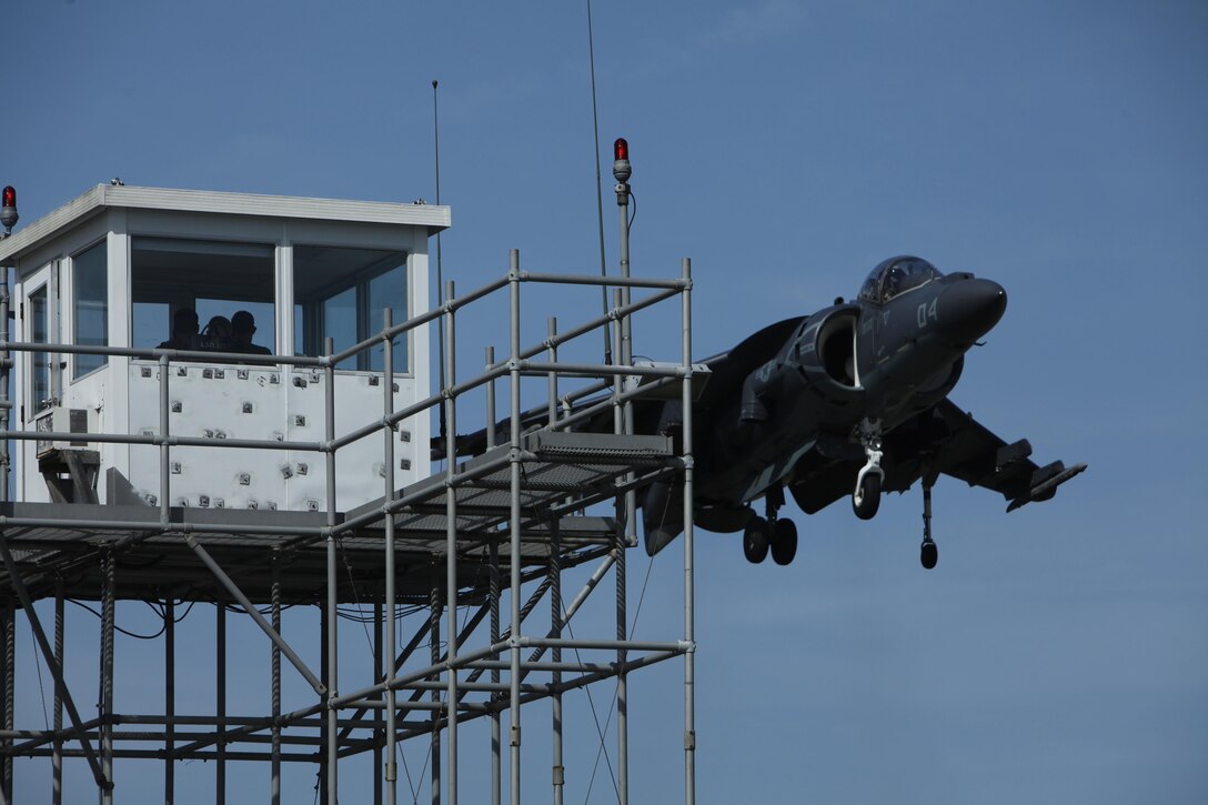 An AV-8B Harrier Pilot with Marine Attack Squadron 223 conducts a vertical landing onto a mock LHD flight deck Monday at Bogue Field. 
