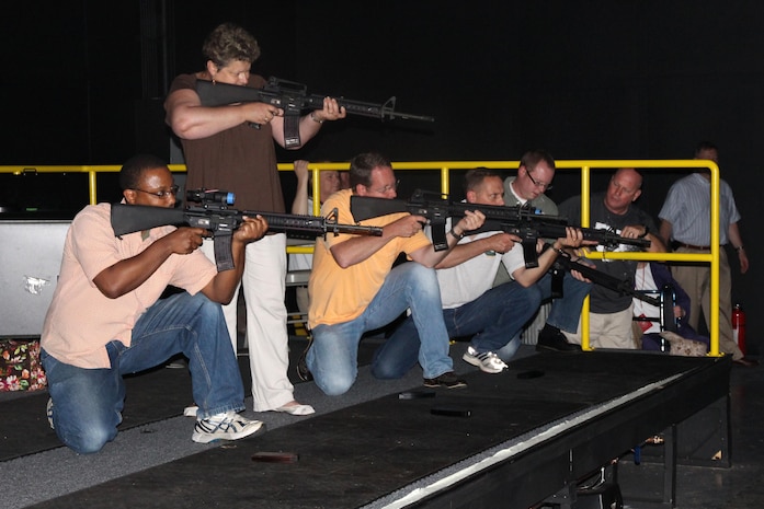 From left: Melvin Coutrier, Sharon Ward, David Keeler, Jack Cave, Jonathan Carpenter and Rick Daley, all with  Combat Support Systems, participate in a May training exercise at Camp Upshur’s Indoor Simulated Marksmanship Trainer. 