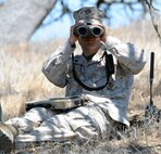 Corporal Charles Stephens with 1st Battalion, 11th Marine Regiment, 1st Marine Division from Camp Pendleton, Calif. uses a Vector 21B laser rangefinder to identify potential targets during the Enhanced Marine Air Ground Task Force Operations Limited Objective Experiment 3 at Army National Guard Post, Camp Roberts, Calif. On his lap is the Strikelink Military Ruggedized Tablet, used to request fire support missions.