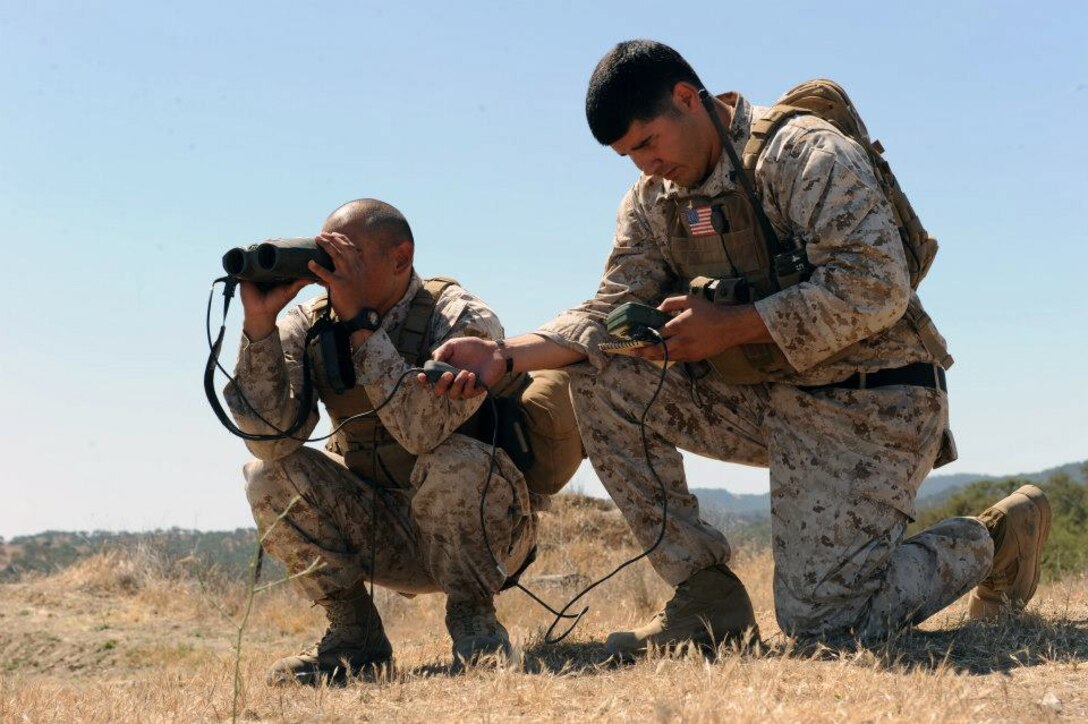 Staff Sergeant Humberto Magana and Corporal Victor Lopez, from Camp Pendleton, Calif., are using a Vector 21B Laser Range Finder and Defense Advanced GPS Receiver to determine coordinates for a close air support target during the first day of the Enhanced Marine Air Ground Task Force Operations Limited Objective Experiment 3. This portion of the exercise focuses on using current Marine Corps systems and methods for fire support.