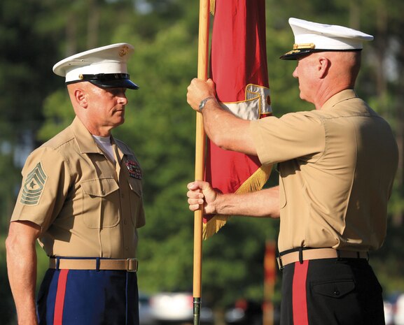 Maj. Gen. Charles L. Hudson, right, outgoing commanding general, Marine Corps Logistics Command, returns the MCLC’s colors and battle streamers to Sgt. Maj. Joseph M. Davenport III, sergeant major, MCLC, Friday, during a relinquishment of command ceremony held at MCLC’s parade field.