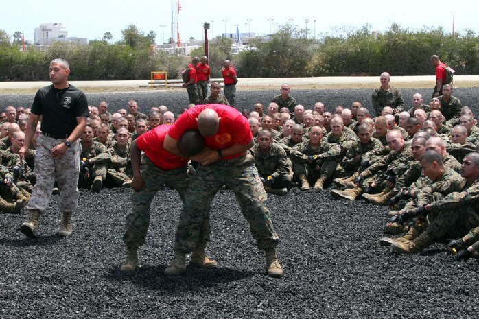 Recruits of Company B, 1st Recruit Training Battalion, watch their drill instructors display the correct way to perform a counter to a choke aboard Marine Corps Recruit Depot San Diego June 6. Recruits learned how to perform chokes and counter to chokes during a lesson in Marine Corps Martial Arts. 