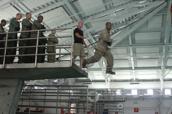 A recruit of Company B, 1st Recruit Training Battalion, jumps from the 10-foot diving board to into the water during swim qualification aboard Marine Corps Recruit Depot San Diego June 4. Swim qualification takes recruits out of their comfort zone by forcing them to swim in full combat utility uniforms and combat boots.