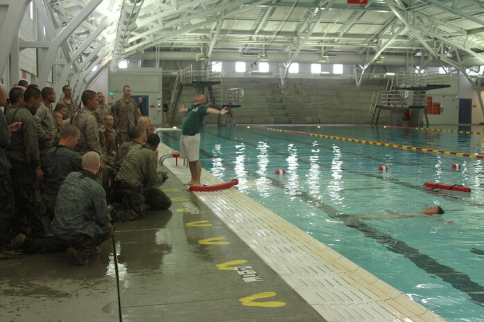 Instructors with Instructional Training Company, Recruit Training Regiment, demonstrate how to tread water properly during swim qualification aboard Marine Corps Recruit Depot San Diego June 4. Recruits are required to tread water for a total of four minutes in the deep end of the pool. 