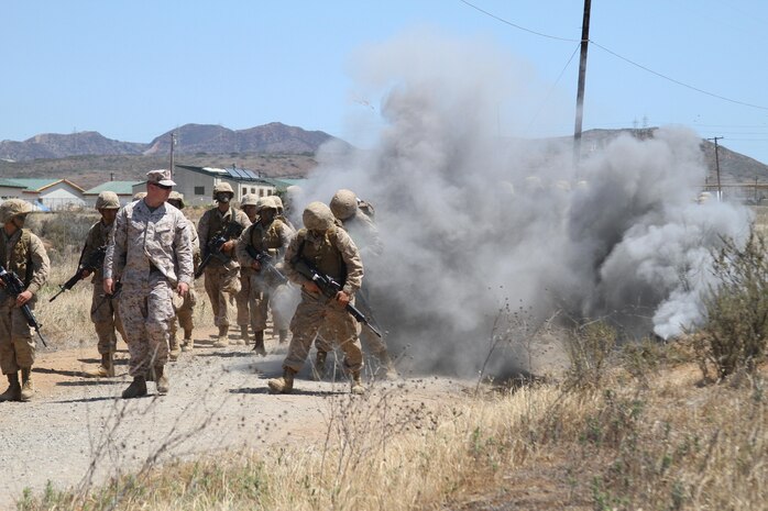 Recruits of Company G, 2nd Recruit Training Battalion, encounter a simulated improvised explosive device during the Crucible Improvised Explosive Device Lane at Edson Range aboard Marine Corps Base Camp Pendleton, Calif., June 4.  Instructors test recruits during the event to see how they will react and handle losing part of their squad to the explosion.