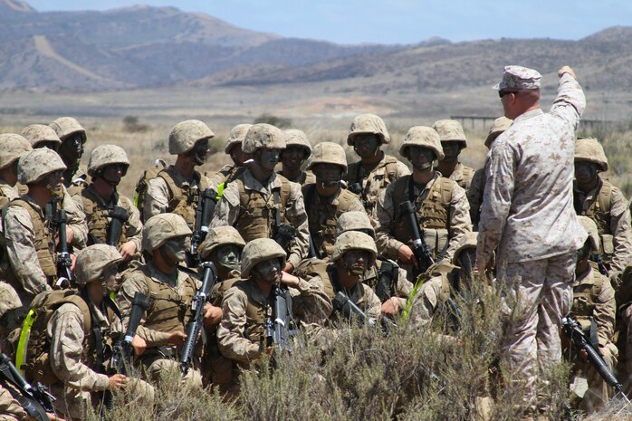 Recruits of Company G, 2nd Recruit Training Battalion, listen to an instructor give a lesson on the improvised explosive device they found during the Crucible Improvised Explosive Device Lane at Edson Range aboard Marine Corps Base Camp Pendleton, Calif., June 4.  Recruits get to experience and see all of the various types of IEDs that have been utilized over the recent years in the combat theater.