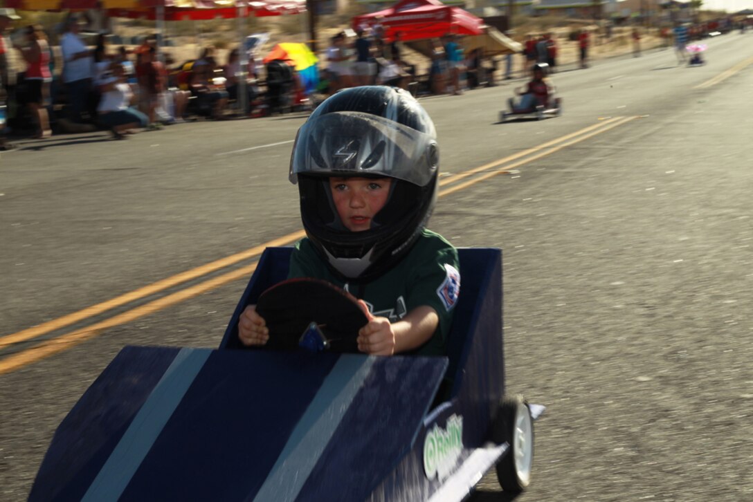 Caden Dickson, 5, streaks by the finish line during the ASYMCA 7th annual Soapbox Derby June 1. Dickson won his first heat during the race.