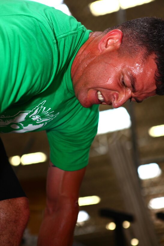 Gunnery Sgt. Randall "Jay" Johnson, an ordnance staff noncommissioned officer with Marine Fighter Attack Squadron 314 "Black Knights" and a Hereford, Texas, native, strains while lifting a heavy bar during a CrossFit workout aboard Marine Corps Air Station Miramar, Calif., May 1. For the past 3 years, Johnson changed his lifestyle in order to improve his physical performance and endurance through CrossFit.