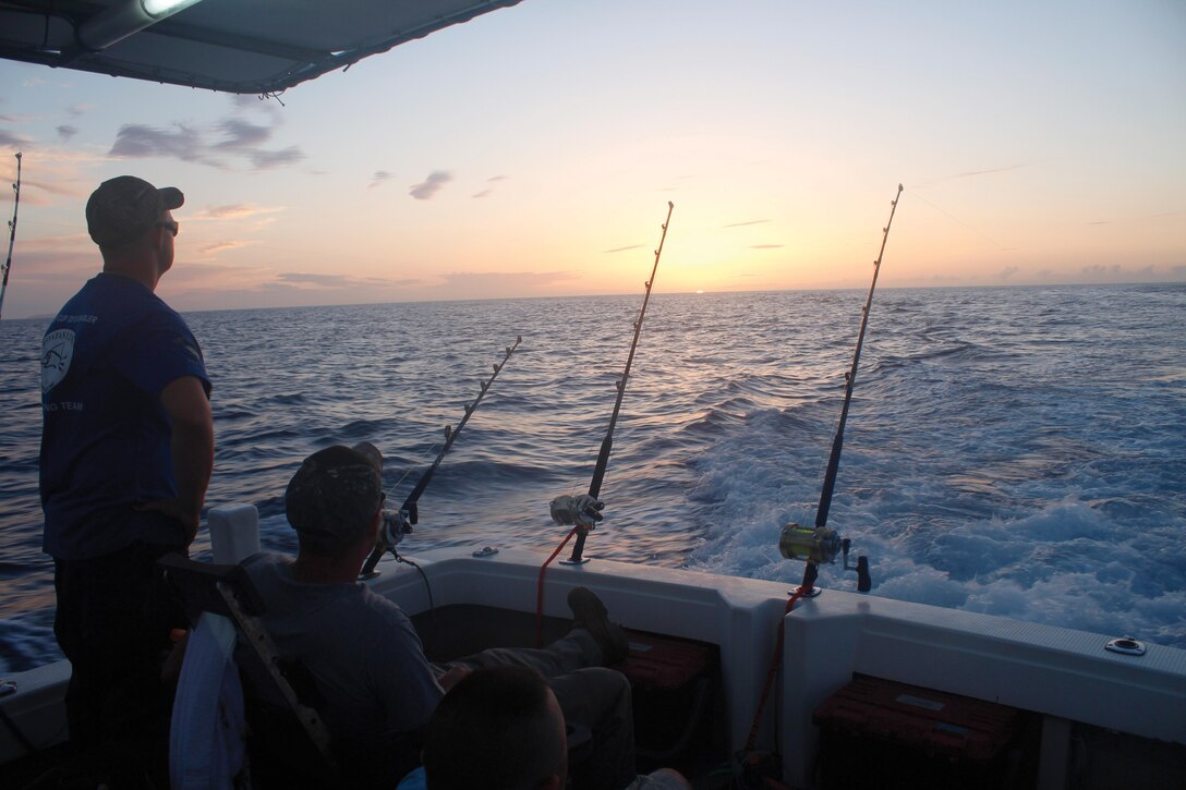 Marines patiently wait for a bite as the sun rises June 9 in the East China Sea during the 9th annual Sam’s Cup International Billfish Tournament off the coast of Okinawa. The tournament officials award the teams for
the heaviest fish and the heaviest total catches with a trophy and bragging rights for the year. The Marines are with 3rd Maintenance Battalion, Combat Logistics Regiment 35, 3rd Marine Logistics Group, III Marine Expeditionary Force. 
