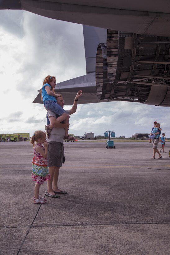 Lt. Cdr. Bryan Emory shows his daughters Abby, standing, and Alexis, the different components of an F/A-18 Hornet fighter jet June 8 at Marine Corps Air Station Futenma. The F/A-18 was one of several aircraft on display during the 35th annual Futenma Flightline Fair hosted at MCAS Futenma. Emory is a reserve coordinator with N-5, plans and policy, Command Task Force 76, Amphibious Force Seventh Fleet, Expeditionary Strike Group Seven.