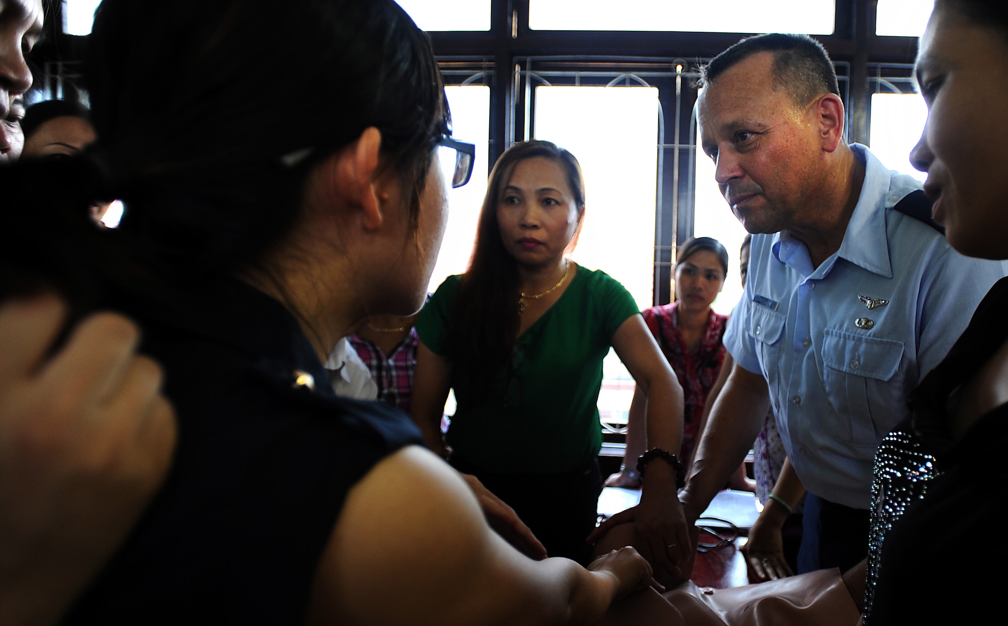 U.S. Air Force Col. John Fischer, an obstetrics and gynecology doctor at the Walter Reed National Military Medical Center Bethesda, Maryland, teaches the hands-on portion of the Prenatal/Obstetrics Emergency Subject Matter Expert Exchange to midwives and physicians from the local community in Dong Hoi, Quang Binh Province, as part of Operation Pacific Angel, June 10, 2013. Operation PACANGEL is a joint and combined humanitarian assistance exercise held in various countries several times a year and includes medical, dental, optometry, engineering programs and a variety of SMEEs. (U.S. Air Force photo by Staff Sgt. Sara Csurilla)

