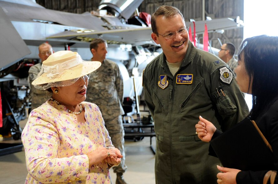 Ms. Kayoko Suzuki, Fuyo-kai chairperson, left, U.S. Air Force Col. Stephen Williams, 35th Fighter Wing commander, middle, and  Kyoko Hasegawa, 35th Fighter Wing Public Affairs chief of community relations, share a conversation at the static display in Hangar 909 at Misawa Air Base, Japan, June 12, 2013. The group members participated in a windshield base tour and enjoyed an F-16 static display at Hangar 909. The purpose of their visit was to learn the mission of Misawa Air Base and deepen their understanding of the relationship between the base and its local communities. (U.S. Air Force photo by Airman 1st Class Kenna Jackson)