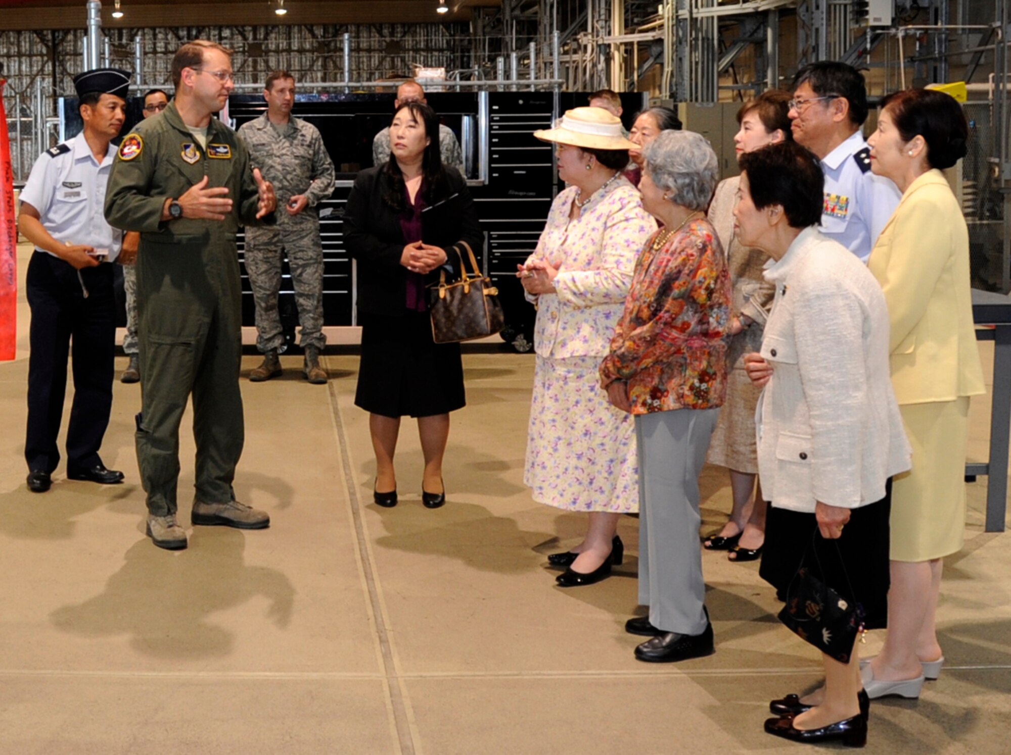U.S. Air Force Col. Williams, 35th Fighter Wing commander, explains to Fuyo-kai members, a Japan Air Self-Defense Force Ladies Group, the capabilities of a U.S. Air Force F-16 Fighting Falcon jet during a static display in Hangar 909 at Misawa Air Base, Japan, June 12, 2013. During the display, the group members were able to see one of the United States fighter jets up close. (U.S. Air Force photo by Airman 1st Class Kenna Jackson)