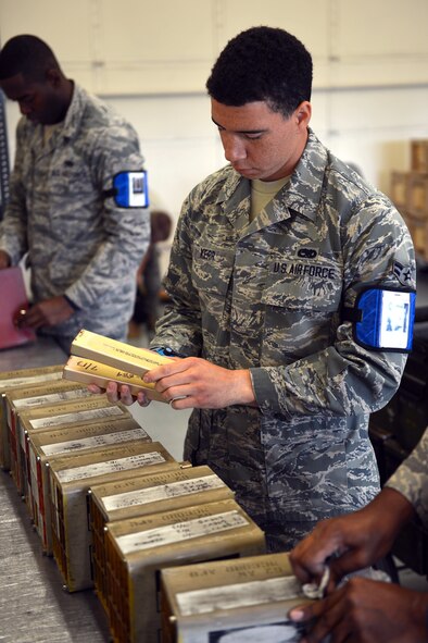 Airman 1st Class Dewayne Kerr (front), 62nd Maintenance Squadron munitions crewmember, and Airman 1st Class Brandon Young (rear), 62nd MXS munitions crewmember, inspects the expiration dates of MJU-62 infrared countermeasure flares, June 10, 2013 at Joint Base Lewis-McChord, Wash.The 62nd MXS munitions flight builds and tracks the service life and serviceability of more than $20,000 of operational countermeasures each year. (U.S. Air Force photo/Airman 1st Class Jacob Jimenez)