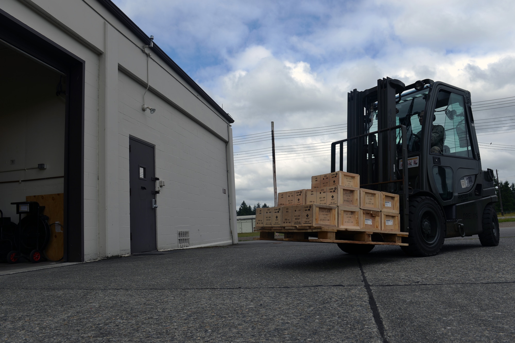 Airman 1st Class Forest Fender, 62nd Maintenance Squadron munitions crewmember, transports a pallet of small arms munitions to a temporary storage facility, while preparing a redistribution order for shipment, June 10, 2013 at Joint Base Lewis-McChord, Wash. The 62nd MXS munitions flight is responsible for supplying munitions to the 627th Security Forces Squadron, 627th Civil Engineering Squadron explosive ordnance disposal team and other base agencies. (U.S. Air Force photo/Airman 1st Class Jacob Jimenez)