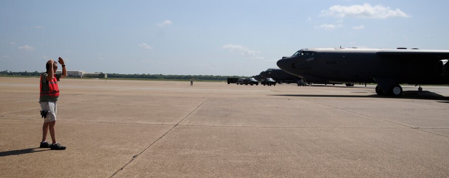 Tech. Sgt. Rob Johnson, 307th Maintenance Squadron, guides a taxiing B-52H Stratofortress prior to launch on Barksdale Air Force Base, La., June 13, 2013. For the past 60 years the B-52 has been a powerful asset in the Air Force arsenal by delivering precision munitions to the battlefield. (U.S. Air Force photo/Airman 1st Class Andrew Moua)