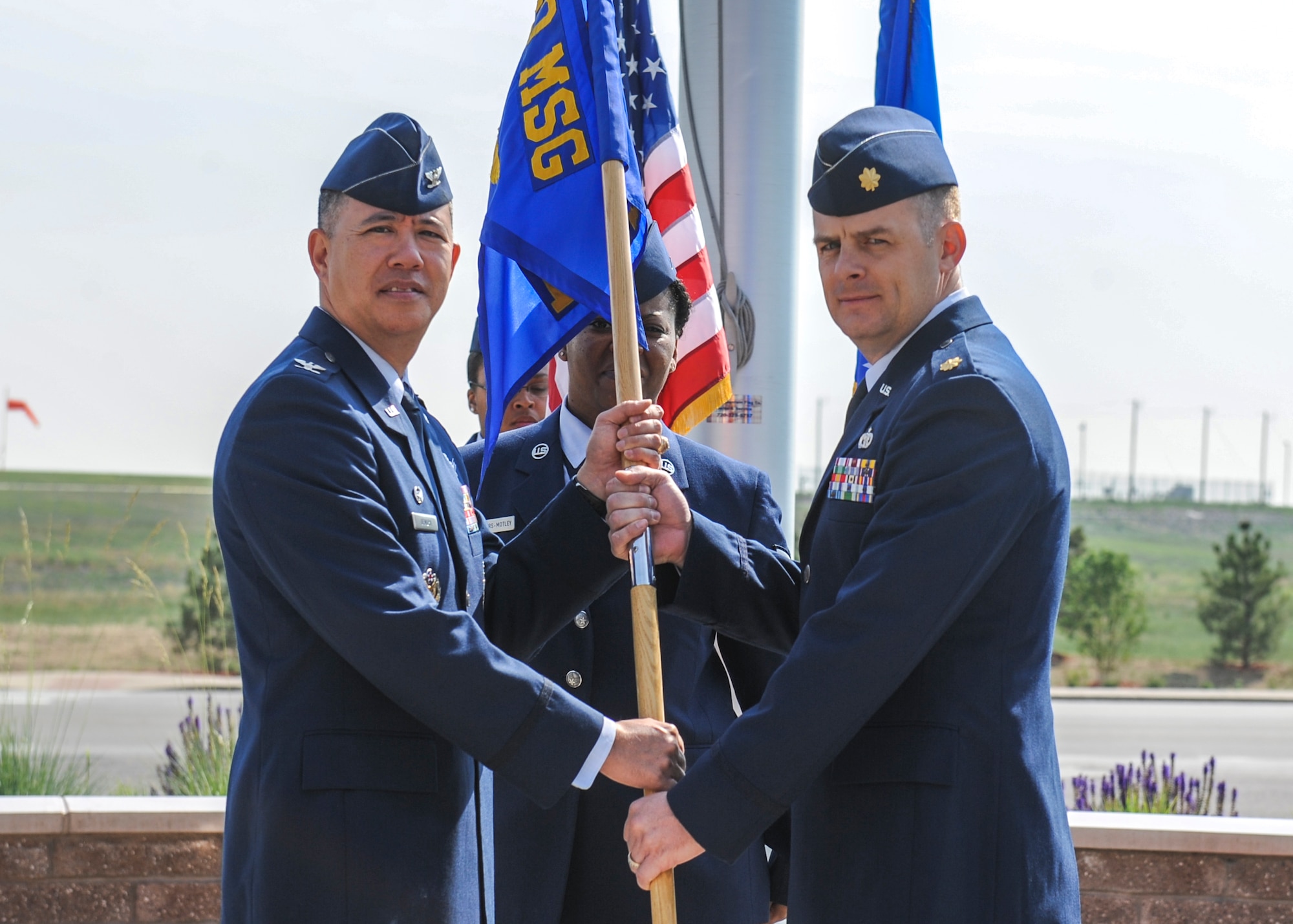 Col. Robert Uemura, left, 460th Mission Support Group commander, hands the guidon to the new 460th Logistics Readiness Squadron commander, Maj. Nicholas Musgrove, at the squadron's change-of-command ceremony June 13, 2013, on Buckley Air Force Base, Colo. The 460th LRS provides logistics support for more than 6,000 active-duty and reserve personnel assigned to Air Force Space Command units and Department of Defense agencies in the Front Range. The unit also sustains combat logistics support by providing overall direction and management of base processes related to vehicles, cargo movement, equipment, deployment planning and bulk fuels. (U.S. Air Force photo by Staff Sgt. Christopher Gross/Released)
