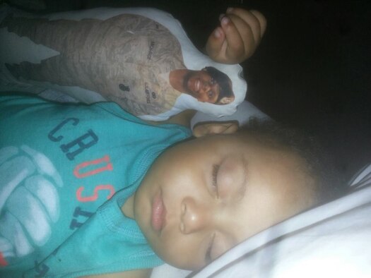 Trey Rice sleeps holding a doll with a photo of his father Staff Sgt. Tony Rice June 11, 2013. Hug-A-Hero dolls are used to help children cope with the stresses of seperation while parents are deployed or away.
(courtesy photo)