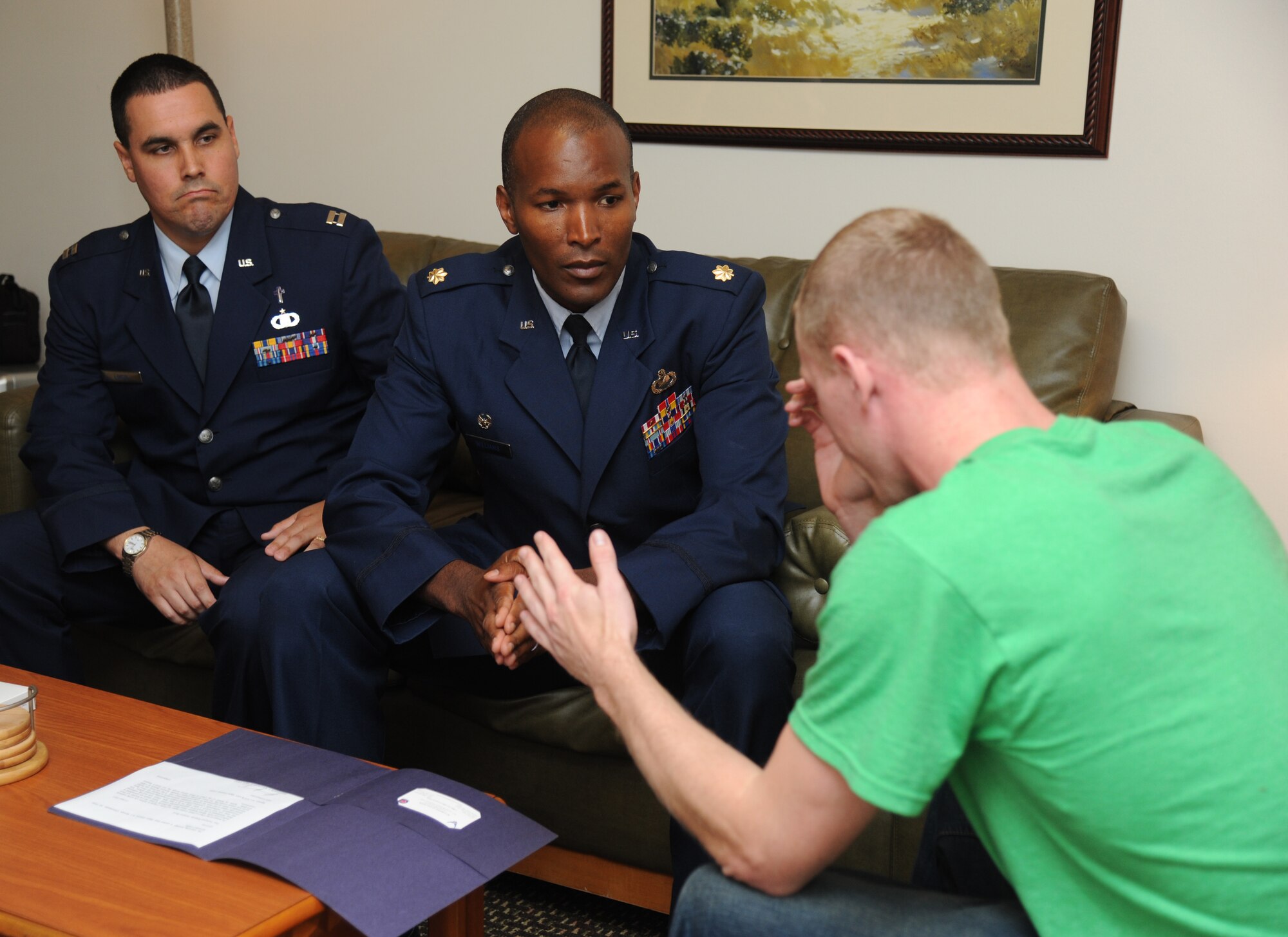Chaplain (Capt.) Mathew Limon, 81st Training Wing, and Maj. Phelemon Williams, 81st Comptroller Squadron commander, comforts 2nd Lt. Nate Morris, 333rd Training Squadron, as he portrays a military spouse who has just been notified of his wife’s death during Keesler's active shooter exercise, June 13, 2013, at Keesler Air Force Base, Miss.  During the two-day exercise, an Air Force couple simulated opening fire, killing three people and injuring 41.  The exercise tested the base's ability to respond to and recover from a mass casualty event.  (U.S. Air Force photo by Kemberly Groue)