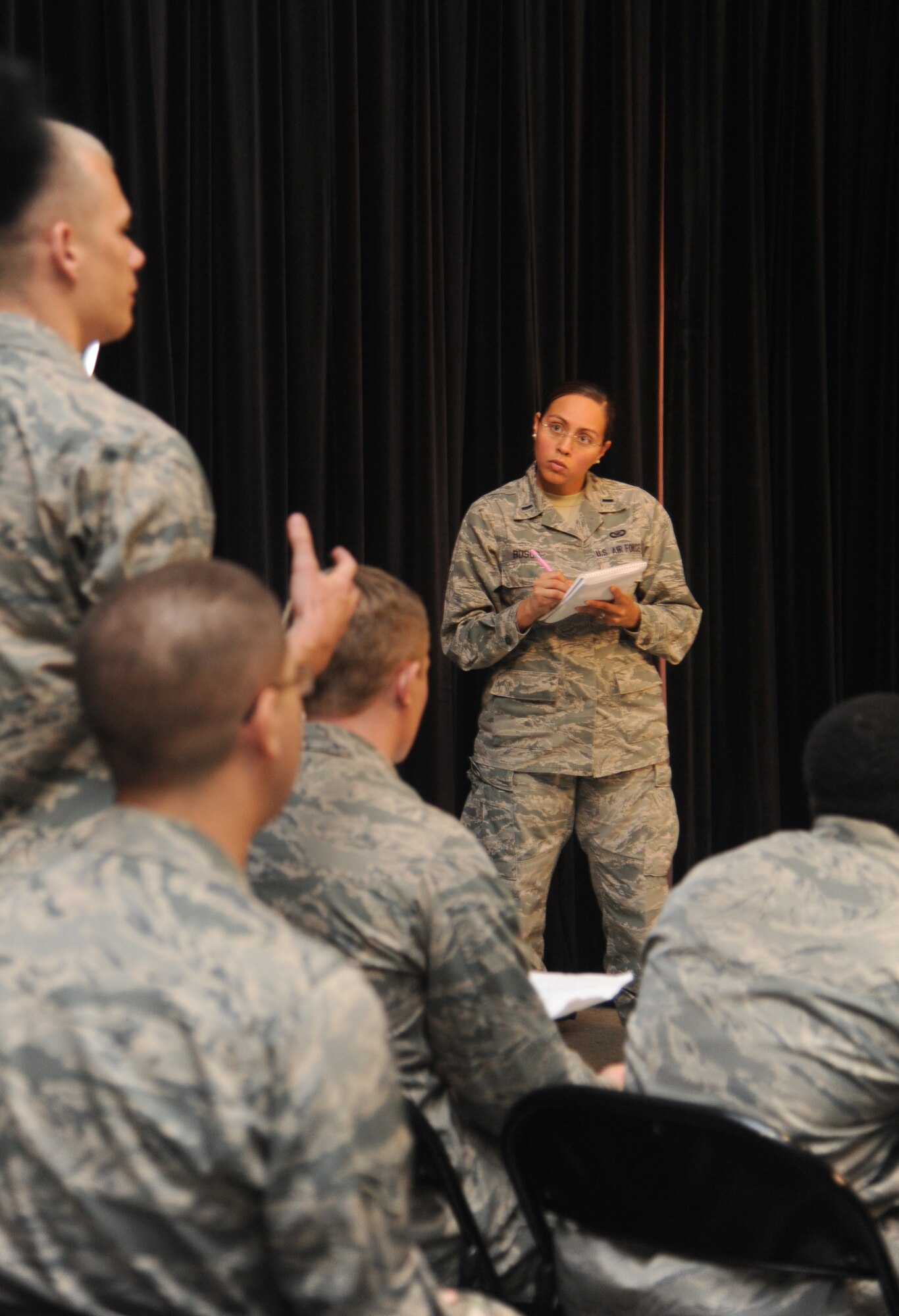 First Lt. Jennifer Bosco, 81st Training Wing chief of Public Affairs, addresses the crowd during a simulated press conference during Keesler's active shooter exercise, June 13, 2013, at Wall Studio, Keesler Air Force Base, Miss.  During the two-day exercise, an Air Force couple simulated opening fire, killing three people and injuring 41.  The exercise tested the base's ability to respond to and recover from a mass casualty event.  (U.S. Air Force photo by Kemberly Groue)
