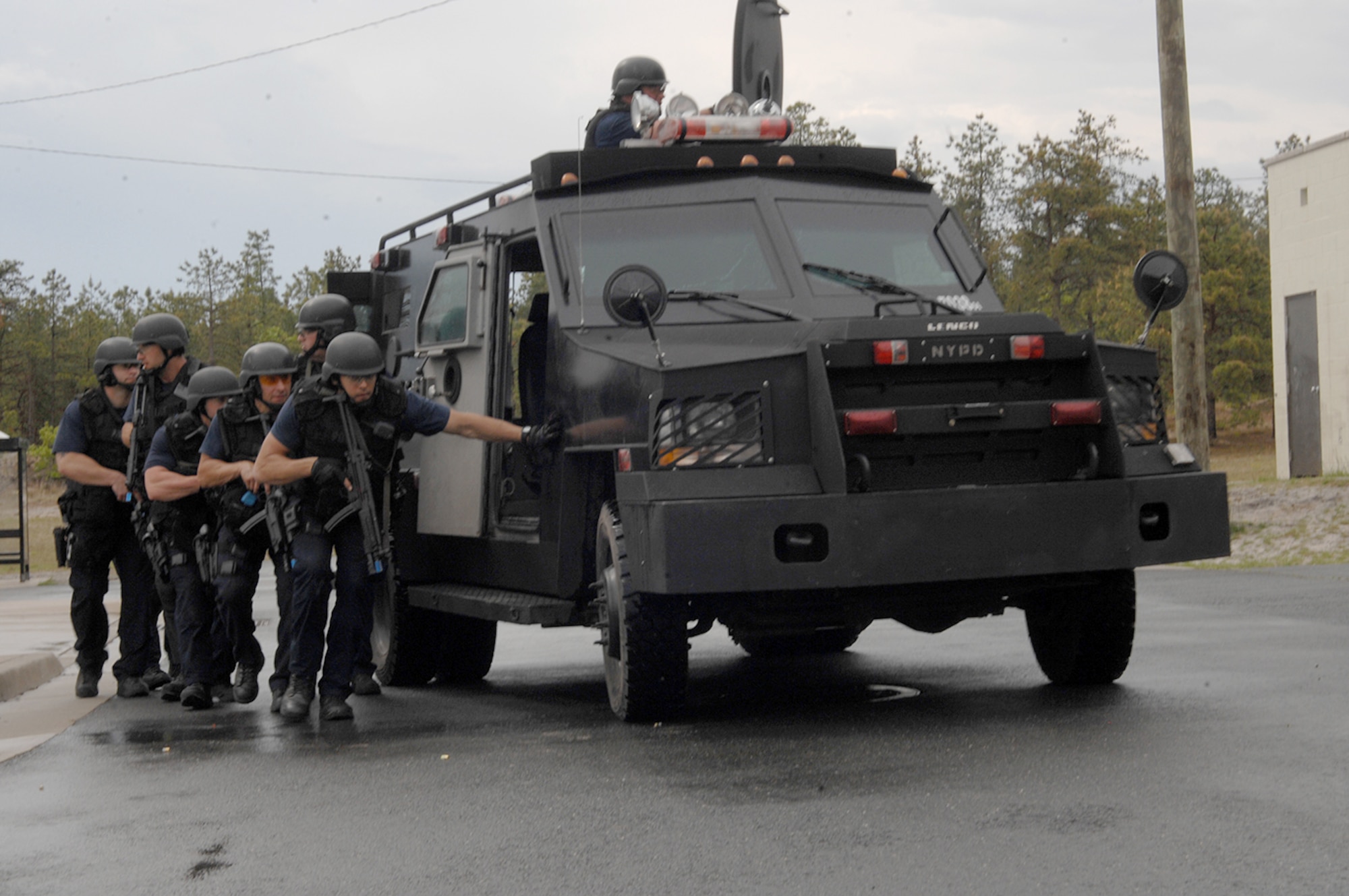Emergency Service Unit New York City police officers and investigators move into position to block sniper fire to protect other officers May 16, 2013, during a field training exercise at Joint Base McGuire-Dix-Lakehurst, N.J. The elite multi-disciplined unit personnel provides specialized support and advanced equipment to NYPD units in such areas as special weapons and tactics, hostage situations, water rescues, high angle rescues and emergency medical treatment. (U.S. Army photo by David Moore/Released)