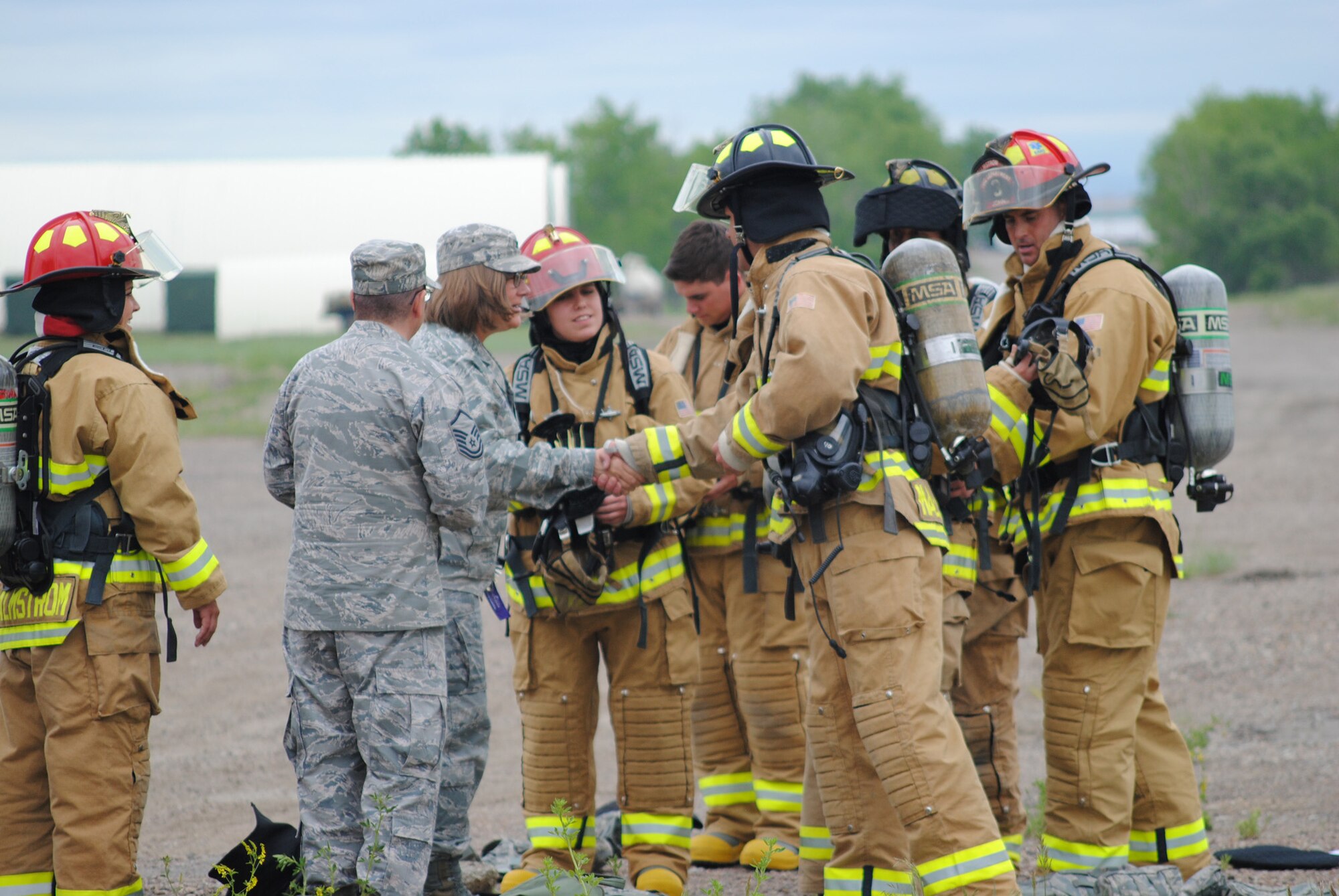 Col. Angela Stout, 341st Mission Support Group commander, shakes hands with the Academy cadets touring Malmstrom’s fire department.  Before the live fire exercise, the cadets alongside Malmstrom firefighters did a walk-through of the trainer to get a feel for the layout for safety purposes.  (U.S. Air Force photo/Senior Airman Cortney Paxton)
