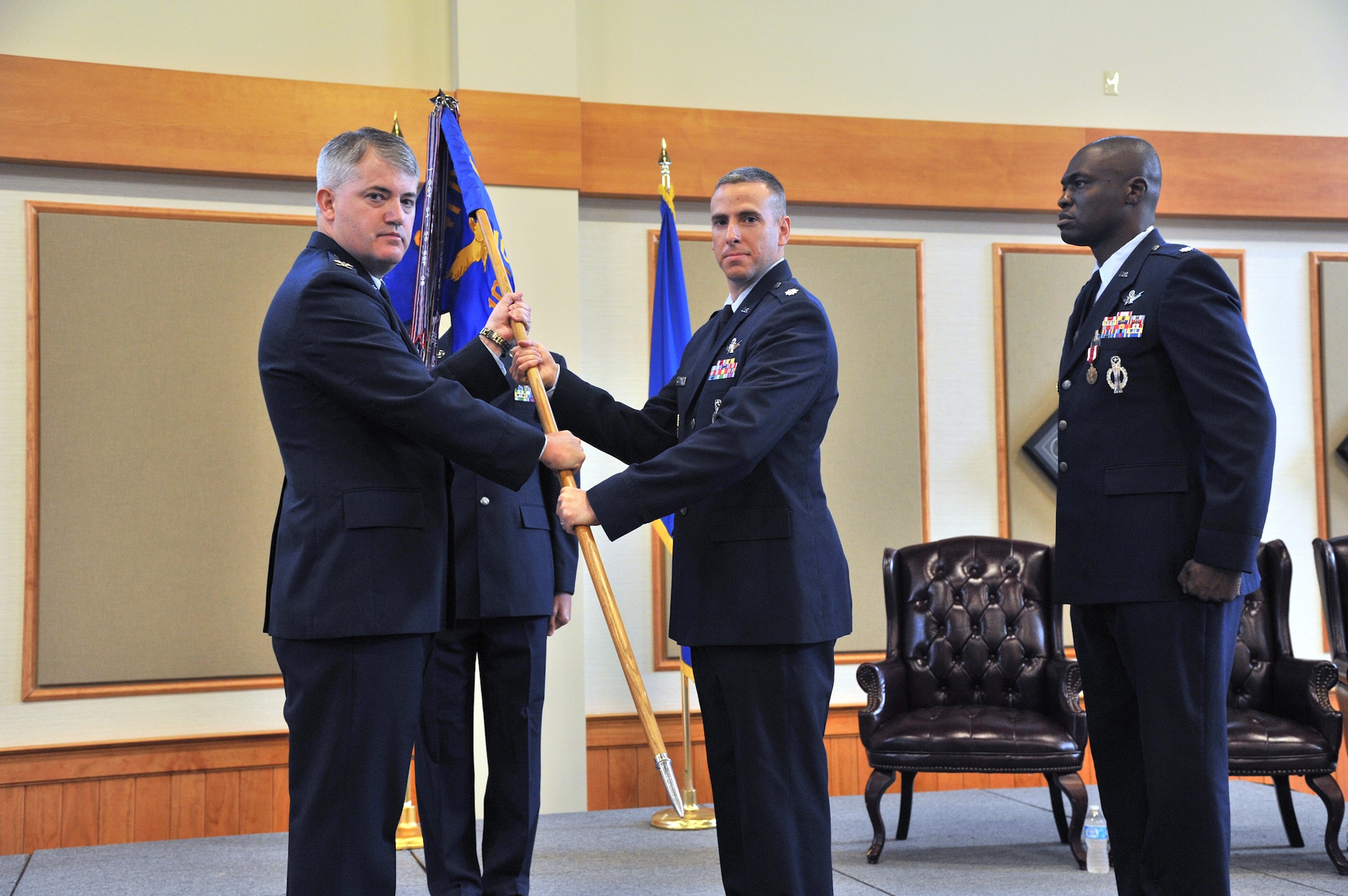 Lt. Col. Michael Calvaresi, center, accepts command of the 10th Missile Squadron from Col. Mark Schuler, 341st Operations Group commander at the Grizzly Bend on June 7.  Lt. Col. Demetrius Walters, the relinquishing commander of the 10th MS, right, looks on.  (U.S. Air Force photo/ John Turner)
