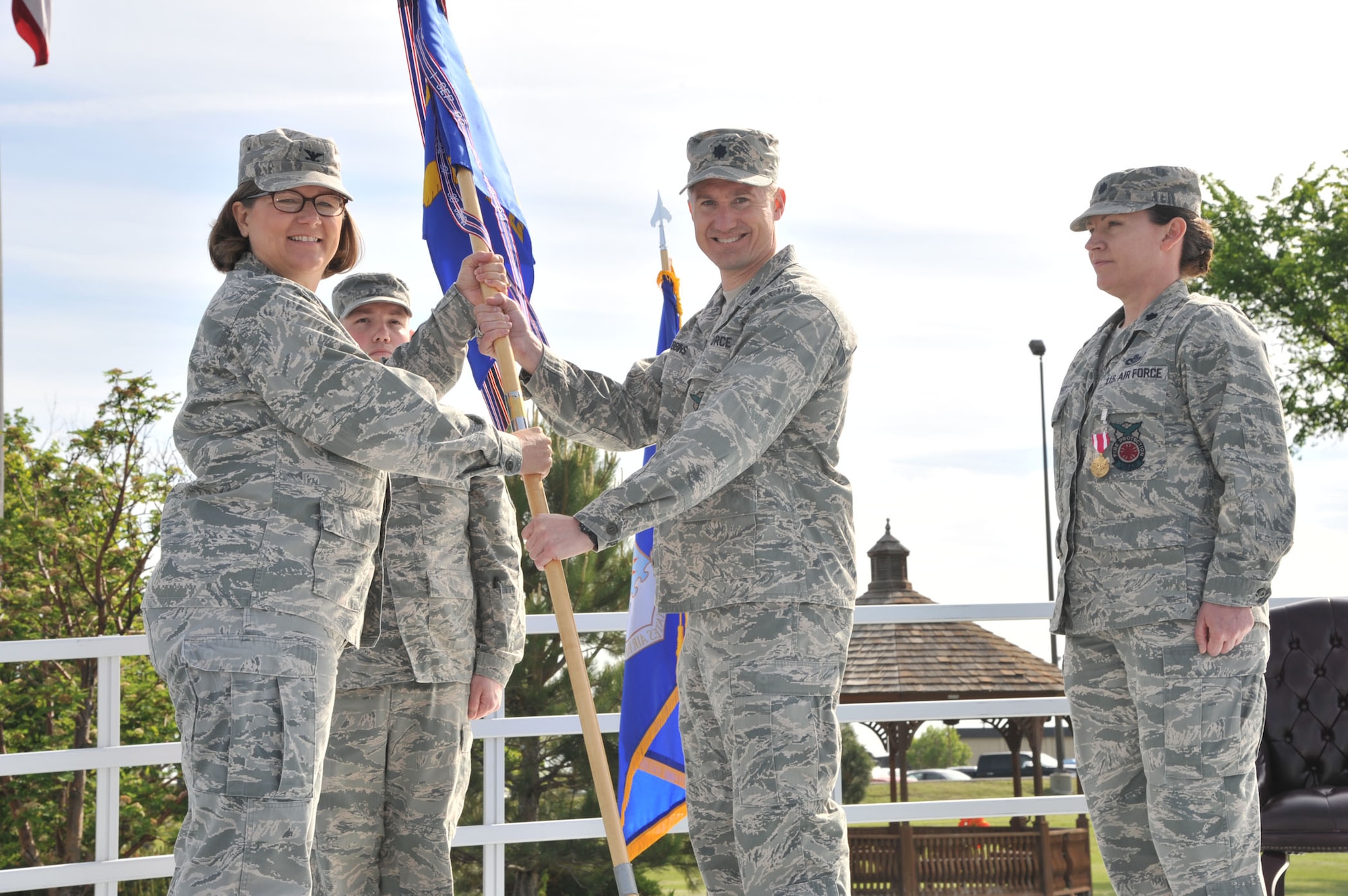 Lt. Col. Walter Gibbins, center, accepts command of the 341st Civil Engineer Squadron from Col. Angela Stout, 341st Mission Support Group commander, at Medal of Honor Park on June 6.   Lt. Col. Sarah Christ, the relinquishing 341st CES commander, right, and Master Sgt. Colin Crandall, 341st CES first sergeant, look on.  (U.S. Air Force photo/ John Turner)