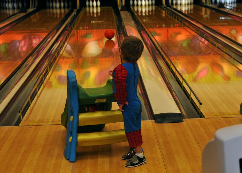 Logan Walker, 3, son of Staff Sgt. Jason Walker, 321st Special Tactics Squadron pararescueman from Albuquerque, N.M., bowls during a Hearts Apart dinner June 12, 2013, at the bowling alley on RAF Mildenhall, England. The 100th Communications Squadron hosted the superhero-themed event. (U.S. Air Force photo by Airman 1st Class Kelsey Waters/Released)