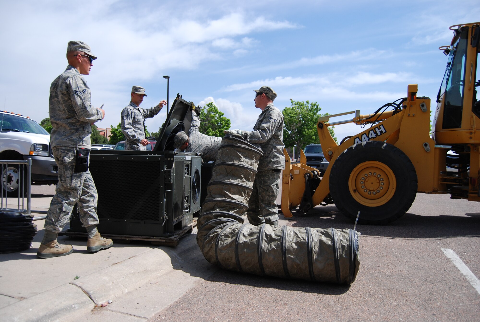 PETERSON AIR FORCE BASE, Colo. – Airmen with the 21st Civil Engineer Squadron set up air conditioning units at the Peterson AFB temporary shelter to provide relief for service members and their families displaced from wildfires burning near Peterson. The shelter can accommodate approximately 100 personnel and is open to any member with base access. (U.S. Air Force photo/Michael Golembesky)