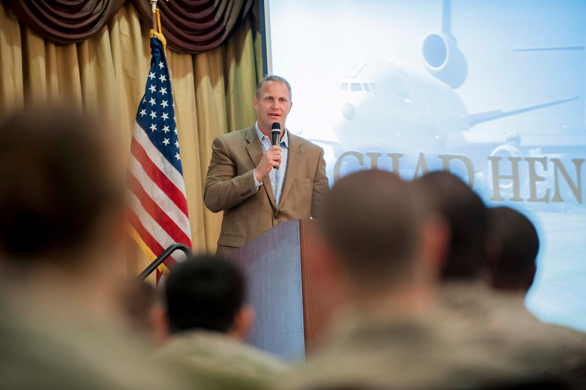 Chad Hennings, former Dallas Cowboys defensive tackle, speaks during the Mission Focus Day at Tommy B's Community Activities Center June 3, 2013, at Joint Base McGuire-Dix-Lakehurst, N.J. Between 700 and 800 305th Air Mobility Wing members started the morning with a two-mile run on the flightline followed by Hennings and various speakers at Tommy B's. Hennings, who flew the A-10 Thunderbolt on 45 missions during his 4-year stint with the Air Force, relayed his message on physical fitness and how it made him a better pilot and football player. (U.S. Air Force photo by Russ Meseroll/Released)