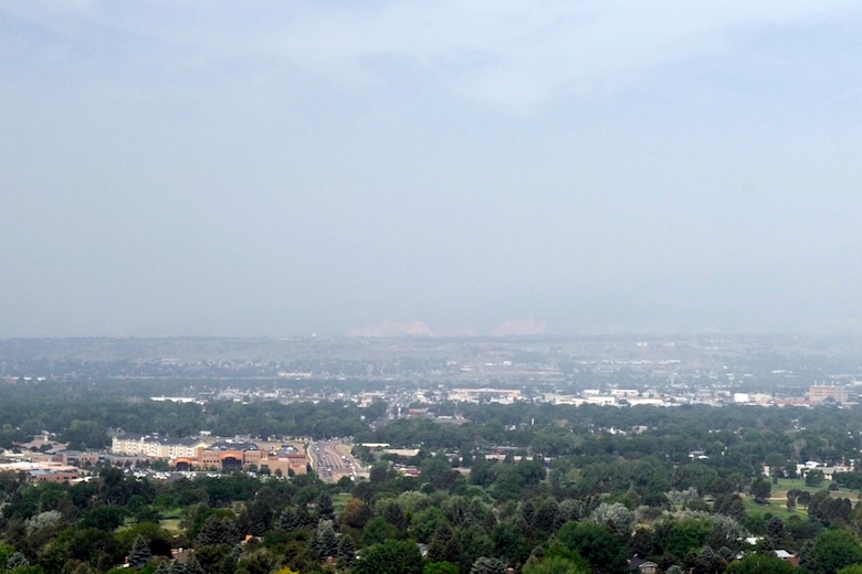 PETERSON AIR FORCE BASE, Colo. – A smoky haze generated by the Black Forest Fire masks the Garden of the Gods and Pikes Peak in this image taken from Palmer Park June 12. The wildfire began June 11 causing widespread evacuations throughout the affected region. The 21st Space Wing is providing firefighters as well as shelter for displaced DOD ID card holders.  (U.S. Air Force photo/Rob Bussard)