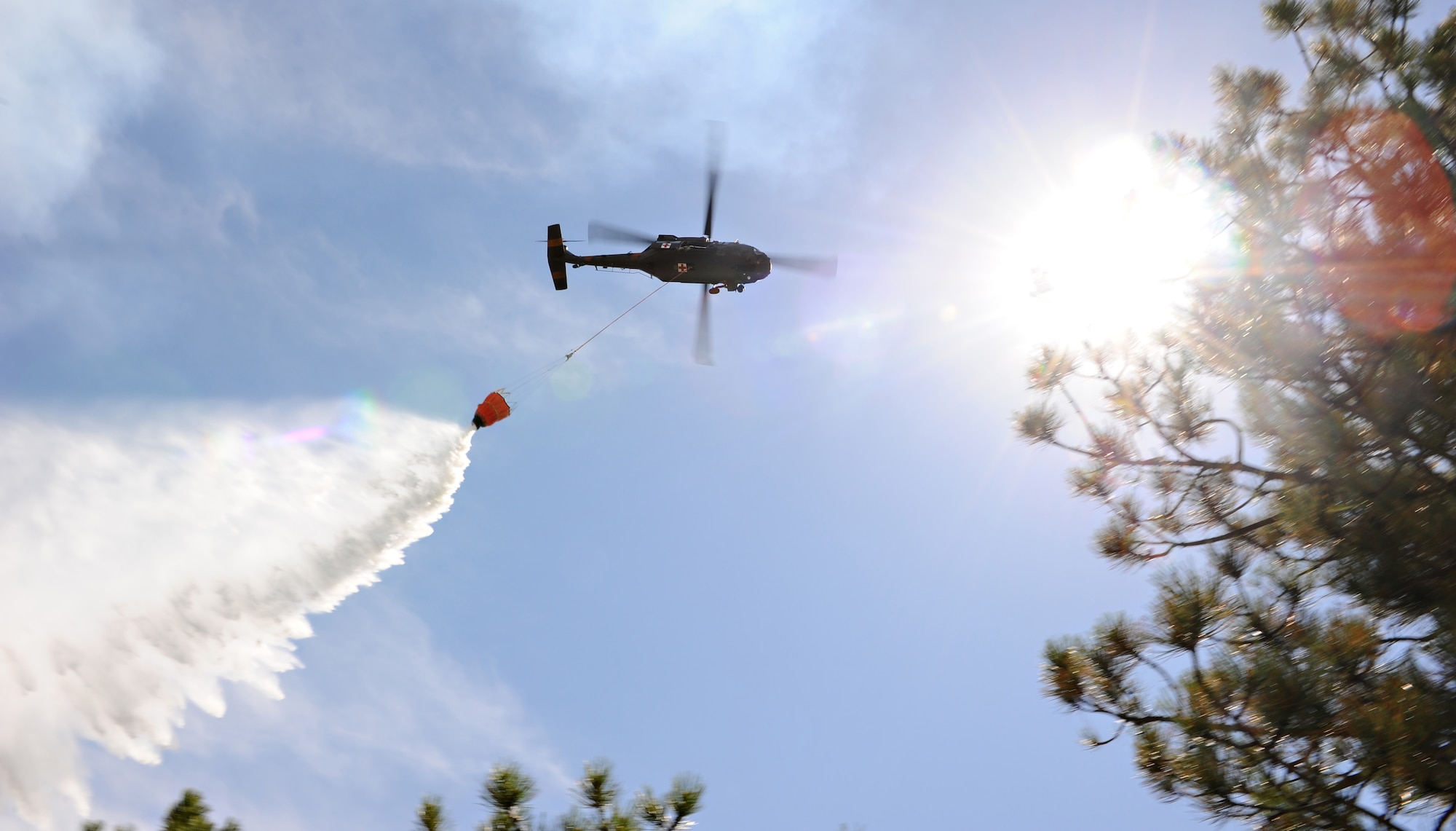 An Army UH-60 Black Hawk helicopter dumps water onto a hotspot during the Black Forest Fire north of Colorado Springs, Colo., June 12, 2013. The Army and Colorado National Guard have deployed four helicopters, and the 52nd Engineer Battalion has deployed to cut lines in advance of the fire. (U.S. Air Force photo/Master Sgt. Christopher DeWitt)